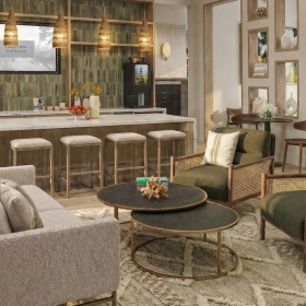 a clubroom with a couch, chairs and a kitchen